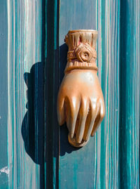 Close-up of statue against blue door