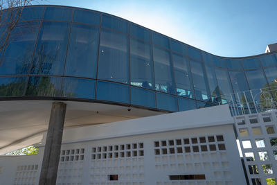 Low angle view of modern building against blue sky