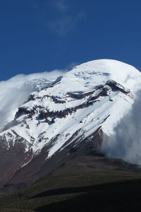 Scenic view of snow covered mountains against sky