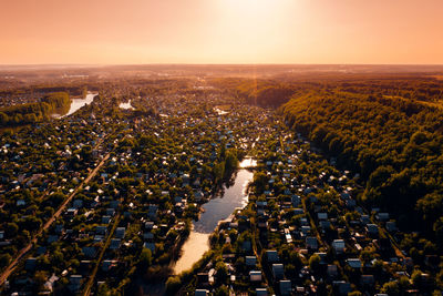 High angle view of illuminated cityscape against sky during sunset