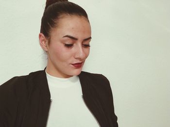 Close-up of young woman over white background