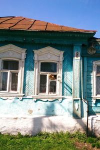 Low angle view of old building against clear blue sky