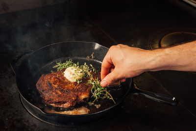 Cropped hands making food in kitchen at home