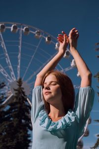 Low angle view of woman in amusement park