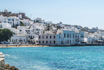 Buildings in city against clear sky