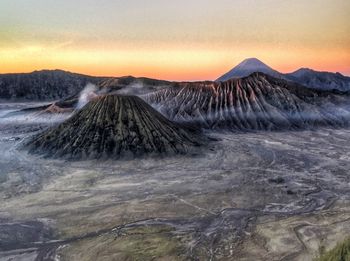 View of volcanic landscape against sky during sunset