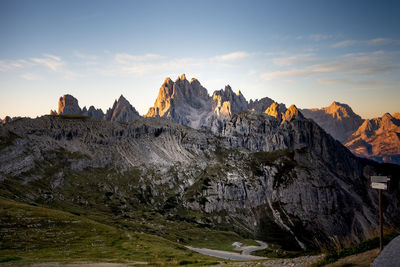 Panoramic view of rocky mountains against sky during sunset