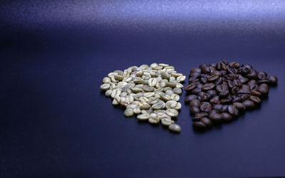 High angle view of coffee beans against blue background