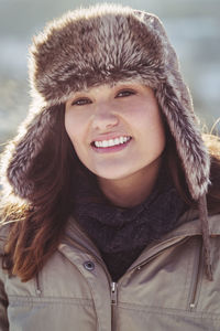 Portrait of happy women in warm clothing standing outdoors during winter