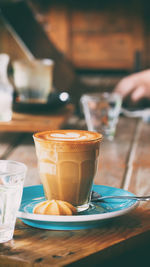 Close-up of cappuccino served on table at cafe