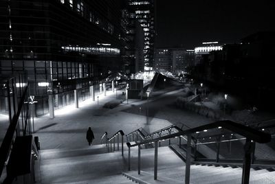 High angle view of illuminated street amidst buildings at night