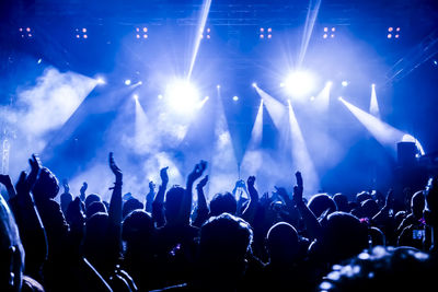 Crowd with arms raised during concert