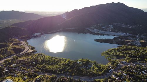 High angle view of sea and mountains against sky