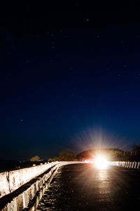 Scenic view of road against sky at night