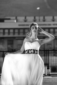 Portrait of a beautiful young woman standing outdoors