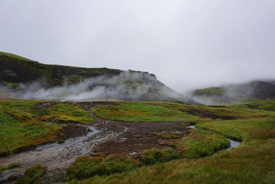 Scenic view of waterfall against sky