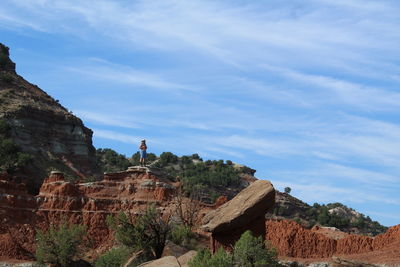 Person standing on mountain at grand canyon national park