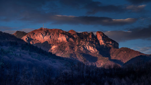 Low angle view of rocky mountains against sky