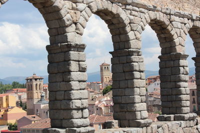 Aqueduct of segovia against sky in city