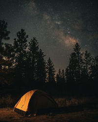 Tent on field against sky at night