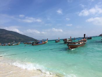 Boats on sea against sky