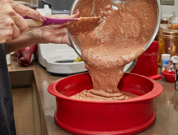 Chef pours the pie ingredients from the bowl into silicone baking dish