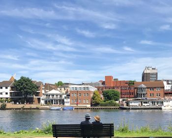 Man by river against sky