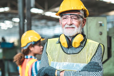 Midsection of man working with yellow umbrella