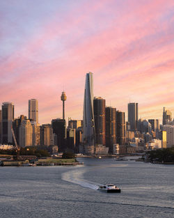 Wide cityscape of sydney at sunset showing the grown tower, international towers and others.