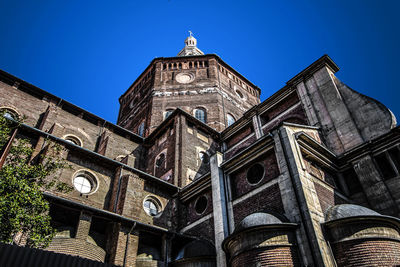 Low angle view of historic church against clear blue sky