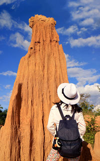 Rear view of woman standing against sky