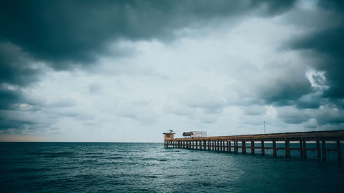 Pier over sea against sky