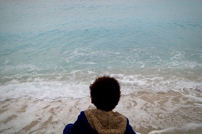 Rear view of man standing at beach