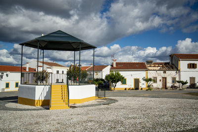 Houses by sea against sky