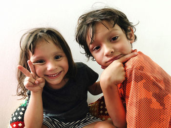 Portrait of a smiling girl and a boy looking at the camera