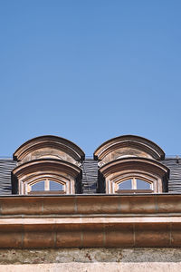 Low angle view of historic building against clear blue sky