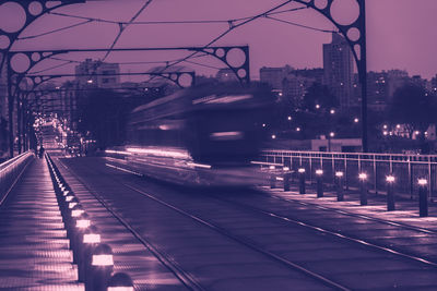 Train on railroad tracks in city against sky