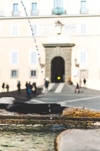 Fountain in city by building