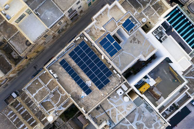 Malta, northern region, mellieha, aerial view of solar panels on rooftops of city houses