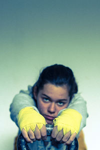 Close-up portrait of young woman holding kettlebell