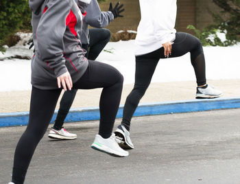 Low section of people walking on road