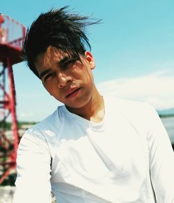 Portrait of young man on shore against sky