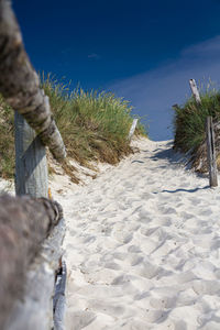 Man on sand at beach against sky