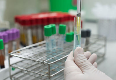 Cropped hand of scientist testing chemical in laboratory