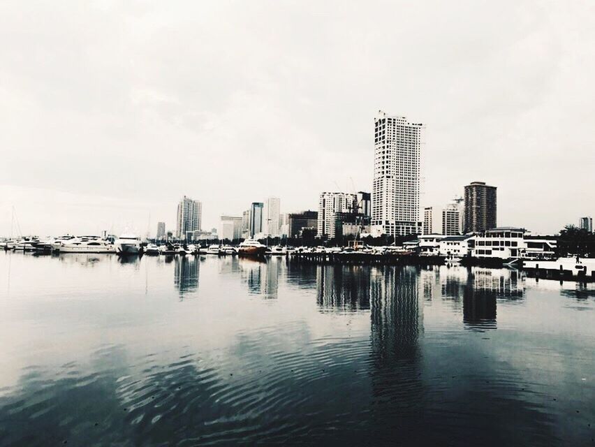 SEA AND CITYSCAPE AGAINST SKY