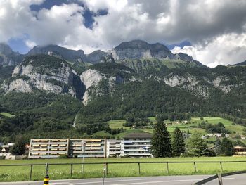 Scenic view of field and mountains against sky