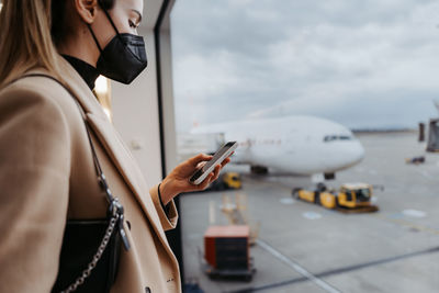 Midsection of woman using mobile phone
