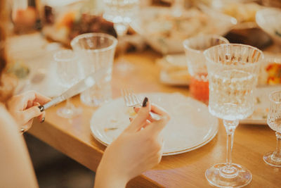 Midsection of woman holding  on table