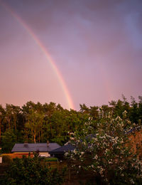 Scenic view of rainbow against sky at sunset