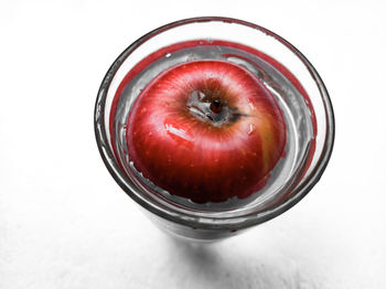 High angle view of apple in glass jar on table